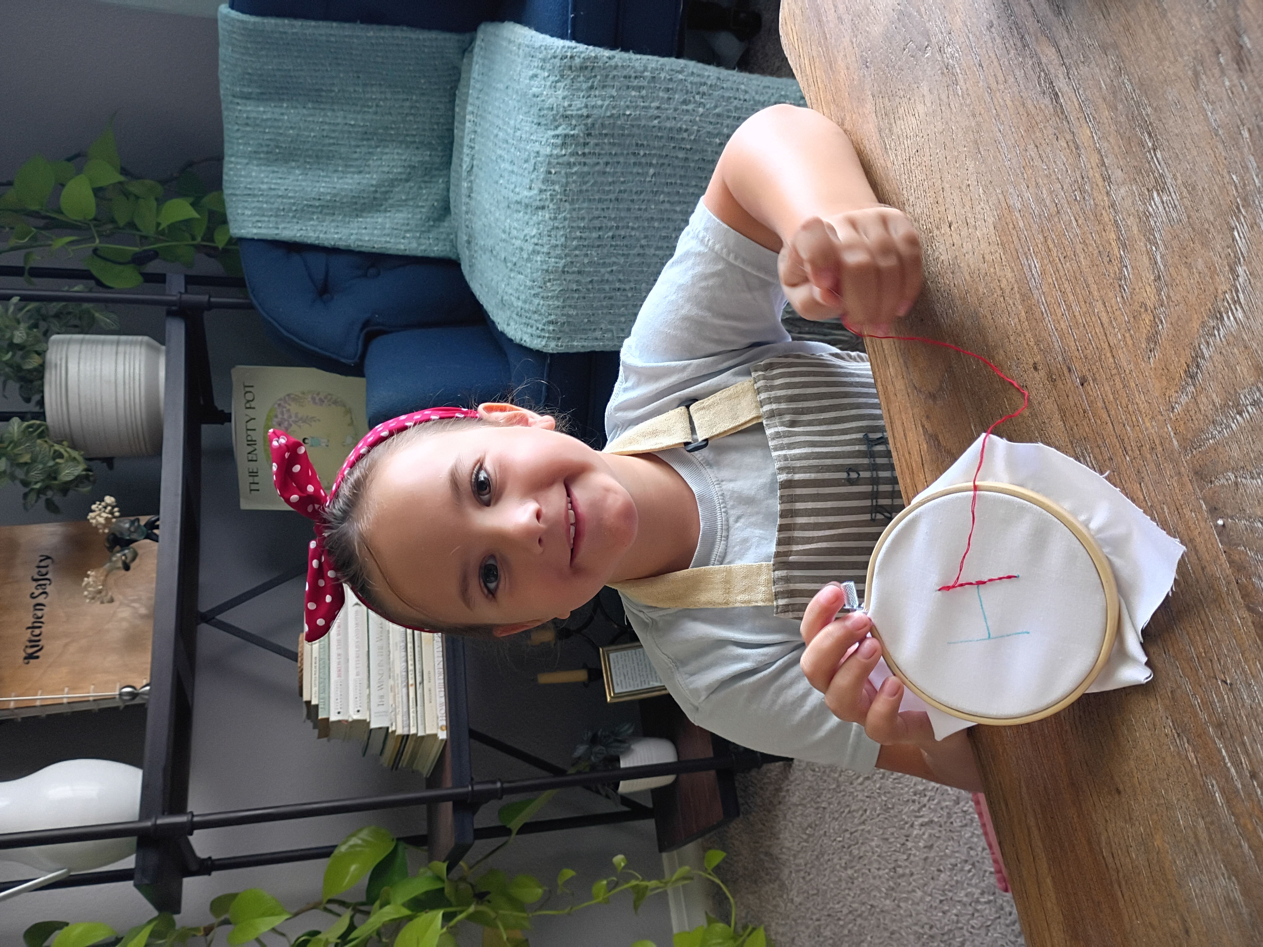 Embroidery hoop, needle, and colorful floss laid out for a kids' workshop